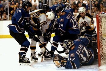 28 Apr 1998:  Tim Taylor #26 of the Boston Bruins fights his way thru Joe Reekie #29 and Joe Juneau #90 of the Washington Capitals during the Bruins 3-0 Eastern Conference playoffs loss at the Fleet Center in Boston, Massachusetts. Mandatory Credit: Craig