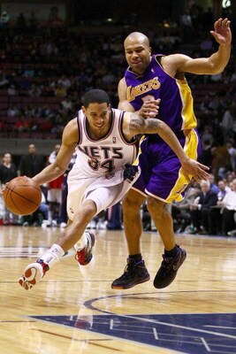 EAST RUTHERFORD, NJ - MARCH 27: Devin Harris #34 of the New Jersey Nets drives past Derek Fisher #2 of the Los Angeles Lakers during their game on March 27, 2009 at the Izod Center in East Rutherford, New Jersey. NOTE TO USER: User expressly acknowledges 