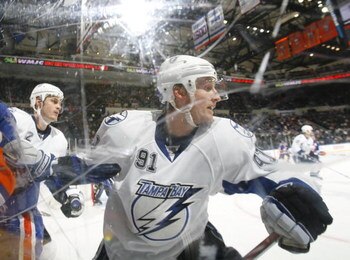 UNIONDALE, NY - APRIL 04: Steven Stamkos #91 of the Tampa Bay Lightning turning away from a check against the New York Islanders in a National Hockey League game at Nassau Coliseum on April 4, 2009 in Uniondale, New York. (Photo by Paul Bereswill/Getty Im