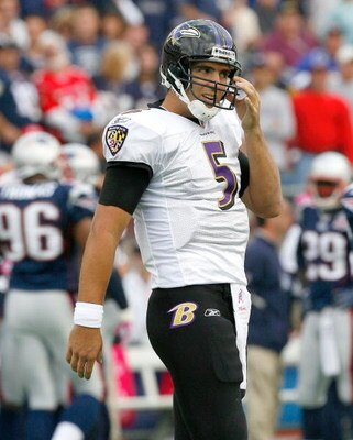 FOXBORO, MA - OCTOBER 4:  Joe Flacco of the Baltimore Ravens pulls grass from his helmet during a game with the New England Patriots at Gillette Stadium on October 4, 2009 in Foxboro, Massachusetts. (Photo by Jim Rogash/Getty Images)