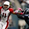 SEATTLE, WA - OCTOBER 18:  Larry Fitzgerald #11 of the Arizona Cardinals breaks a tackle by Jordan Babineaux #27 of the Seattle Seahawks at Qwest Field on October 18, 2009 in Seattle, Washington.  (Photo by Jonathan Ferrey/Getty Images)