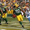 GREEN BAY, WI - OCTOBER 18: Atari Bigby #20 of the Green Bay Packers celebrates an interception in the end zone on a pass intended for John Standeford #16 of the Detroit Lions as teammates Charles Woodson #21 and Nick Barnett#56 run off the field at Lambe