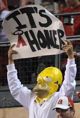 ANAHEIM, CA - OCTOBER 09:  A fan of the Los Angeles Angels of Anaheim dressed as 'Homer Simpson' hold a sign in support of the Angels during Game Two of the ALDS against the Boston Red Sox during the 2009 MLB Playoffs at Angel Stadium on October 9, 2009 i