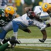 GREEN BAY, WI - OCTOBER 18:  Kevin Smith #34 of the Detroit Lions is tackled by Ryan Pickett #79 and A.J. Hawk #50 of the Green Bay Packers at Lambeau Field on October 18, 2009 in Green Bay, Wisconsin. The Packers defeated the Lions 26-0. (Photo by Jonath