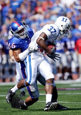 LAWRENCE, KS - SEPTEMBER 19:  Johnny Williams #37 of the Duke Blue Devils carries the ball as Justin Thornton #46 of the Kansas Jayhawks defends during the 1st half of the game at Kivisto Field at Memorial Stadium on September 19, 2009 in Lawrence, Kansas