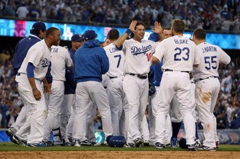 LOS ANGELES, CA - OCTOBER 08:  The Los Angeles Dodgers celebrate after Mark Loretta #5 hit a walk-off RBI to defeat the St. Louis Cardinals in Game Two of the NLDS during the 2009 MLB Playoffs at Dodger Stadium on October 8, 2009 in Los Angeles, Californi