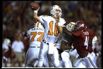 14 OCT 1995:  TENNESSEE QUARTERBACK PEYTON MANNING THROWS THE FOOTBALL AS PRESSURE IS APPLIED DURING THE VOLUNTEERS 41-14 VICTORY OVER THE ALABAMA CRIMSON TIDE AT LEGION FIELD IN BIRMINGHAM, ALABAMA.  Mandatory Credit:  Al Bello/Allsport