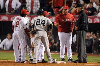 ANAHEIM, CA - OCTOBER 20:  Manager Mike Scioscia of the Los Angeles Angels of Anaheim questions a call with the third base umpire Tim McClelland after Mike Napol #44 (Not Shown) forced Jorge Posada #20 (Not Shown) of the New York Yankees at home plate dur
