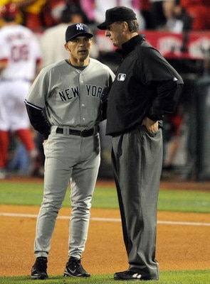 ANAHEIM, CA - OCTOBER 20:  Manager Joe Girardi of the New York Yankees talks to third base umpire Tim McClelland after the top of the forth inning in Game Four of the ALCS against the Los Angeles Angels of Anaheim during the 2009 MLB Playoffs at Angel Sta