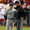 ANAHEIM, CA - OCTOBER 20:  Manager Joe Girardi of the New York Yankees talks to third base umpire Tim McClelland after the top of the forth inning in Game Four of the ALCS against the Los Angeles Angels of Anaheim during the 2009 MLB Playoffs at Angel Sta