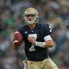 SOUTH BEND, IN - OCTOBER 03: Jimmy Clausen #7 of the Notre Dame Fighting Irish looks for a receiver against the Washington Huskies on October 3, 2009 at Notre Dame Stadium in South Bend, Indiana. Notre Dame defeated Washington 37-30 in overtime. (Photo by