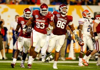 MIAMI - JANUARY 08:  (L-R) Keenan Calhoun #22, Gerald McCoy #93 and Adrian Taylor #86 of the Oklahoma Sooners celebrate a defensive stop against the Florida Gators during the FedEx BCS National Championship game at Dolphin Stadium on January 8, 2009 in Mi