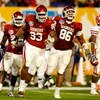 MIAMI - JANUARY 08:  (L-R) Keenan Calhoun #22, Gerald McCoy #93 and Adrian Taylor #86 of the Oklahoma Sooners celebrate a defensive stop against the Florida Gators during the FedEx BCS National Championship game at Dolphin Stadium on January 8, 2009 in Mi