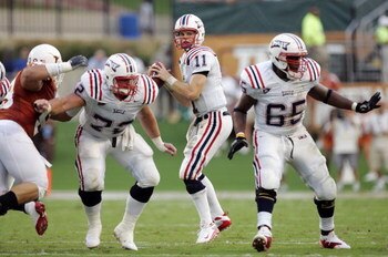 AUSTIN, TX - AUGUST 30:  Quarterback Rusty Smith #11 of the Florida Atlantic Owls looks to throw as lineman David Matlock #72 and Brandon Jackson #65 block against the Texas Longhorns in the second quarter at Darrell K Royal-Texas Memorial Stadium on Augu