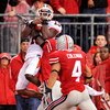 COLUMBUS, OH - SEPTEMBER 26:  Wide receiver Chris Duvalt #15 of the Illinois Fighting Illini hauls in a long pass but is forced out of bounds by Chimdi Chekwa #5 and Kurt Coleman #4 of the Ohio State Buckeyes at Ohio Stadium on September 26, 2009 in Colum