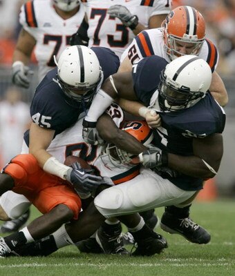 STATE COLLEGE, PA - SEPTEMBER 12: Linebacker Sean Lee #45 and tackle Ollie Ogbu #85 of the Penn State Nittany Lions  tackle running back Antwon Bailey #29 of the Syracuse Orangemen during the first half at Beaver Stadium  September 12, 2009 in State Colle