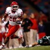 NEW ORLEANS - OCTOBER 17:  Chris Wilson #26 of the Houston Cougars runs past Taylor Echols #15 of the Tulane Green Wave at the Louisiana Superdome on October 17, 2009 in New Orleans, Louisiana. The Cougars defeated the Green Wave 44-16.  (Photo by Chris G