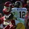 DALLAS - JANUARY 01:  Quarterback Casey Dick #11 of the Arkansas Razorbacks is sacked by Sean Weatherspoon #12 of the Missouri Tigers during the AT&T Cotton Bowl Classic on January 1, 2008 at the Cotton Bowl in Dallas, Texas.  (Photo by Ronald Martinez/Ge