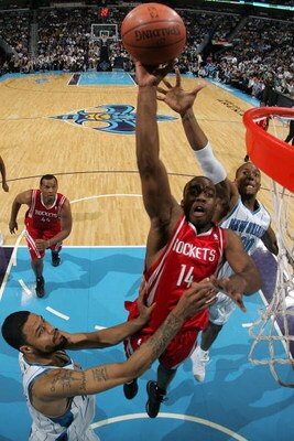 NEW ORLEANS - DECEMBER 26:  Carl Landry #14 of the Houston Rockets makes a shot over David West #30 and Tyson Chandler #6 of the New Orleans Hornets on December 26, 2008 at the New Orleans Arena in New Orleans, Louisiana.   The Hornets defeated the Rocket