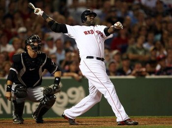 BOSTON - AUGUST 26:  David Ortiz #34 of the Boston Red Sox hits a solo home run at the bottom of the 9th inning to win the game as catcher A.J. Pierzynski #23 of the Chicago White Sox defends on August 26, 2009 at Fenway Park in Boston, Massachusetts. The