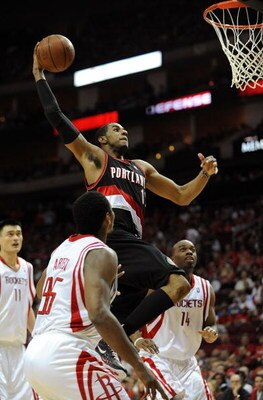 HOUSTON - APRIL 24:  Forward LaMarcus Aldridge #12 of the Portland Trail Blazers makes the slam dunk against Ron Artest #96 of the Houston Rockets in Game Three of the Western Conference Quarterfinals during the 2009 NBA Playoffs at Toyota Center on April