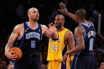 LOS ANGELES, CA - APRIL 21:  Carlos Boozer #5 of the Utah Jazz gives teammate Ronnie Brewer #9 a high five as Kobe Bryant #24 of the Los Angeles Lakers stands between them in Game Two of the Western Conference Quarterfinals during the 2009 NBA Playoffs at