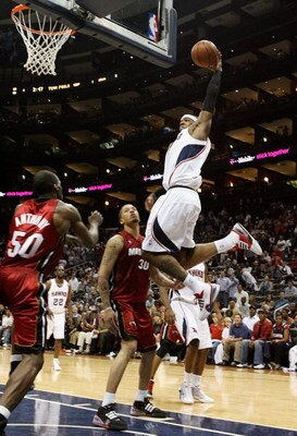 ATLANTA - MAY 03:  Josh Smith #5 of the Atlanta Hawks dunks over Joel Anthony #50 and Michael Beasley #30 of the Miami Heat during Game Seven of the Eastern Conference Quarterfinals at Philips Arena on May 3, 2009 in Atlanta, Georgia. The Hawks defeated t