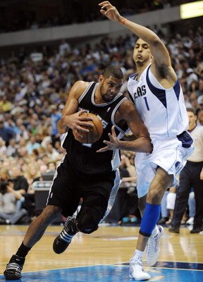 DALLAS - APRIL 25:  Forward Tim Duncan #21 of the San Antonio Spurs dribbles the ball past Ryan Hollins #1 of the Dallas Mavericks in Game Four of the Western Conference Quarterfinals during the 2009 NBA Playoffs at American Airlines Center on April 25, 2