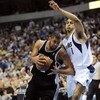 DALLAS - APRIL 25:  Forward Tim Duncan #21 of the San Antonio Spurs dribbles the ball past Ryan Hollins #1 of the Dallas Mavericks in Game Four of the Western Conference Quarterfinals during the 2009 NBA Playoffs at American Airlines Center on April 25, 2