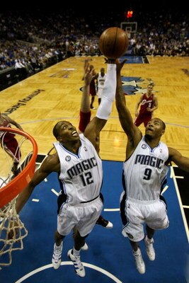 ORLANDO, FL - MAY 24:  Dwight Howard #12 and Rashard Lewis #9 of the Orlando Magic rebound the ball against the Cleveland Cavaliers in Game Three of the Eastern Conference Finals during the 2009 NBA Playoffs at the the Amway Arena on May 24, 2009 in Orlan