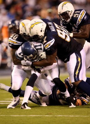 SAN DIEGO - AUGUST 15:  Linebacker Antwan Applewhite #90 and defensive end Vaughn Martin #92of the San Diego Chargers tackle receiver Deon Butler #11 of the Seattle Seahawks on August 15, 2009 at Qualcomm Stadium in San Diego, California.  (Photo by Steph
