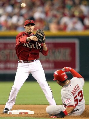PHOENIX - JUNE 28:  Infielder Felipe Lopez #2 of the Arizona Diamondbacks throws over the sliding Bobby Abreu #53 of the Los Angeles Angels of Anaheim attempting a double play during the seventh inning of the major league baseball game at Chase Field on J