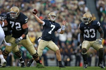 SOUTH BEND, IN - OCTOBER 03: Jimmy Clausen #7 of the Notre Dame Fighting Irish passes the ball as teammates Paul Duncan #72 and Robert Hughes #33 look to block against the Washington Huskies on October 3, 2009 at Notre Dame Stadium in South Bend, Indiana.
