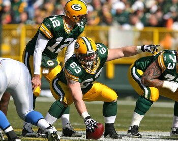 GREEN BAY, WI - OCTOBER 18: Scott Wells #63 of the Green Bay Packers points out a defensive formation before snapping the ball to Aaron Rodgers #12 during a game against the Detroit Lions at Lambeau Field on October 18, 2009 in Green Bay, Wisconsin. The P