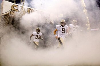 NEW ORLEANS - OCTOBER 18:  Drew Brees #9 of the New Orleans Saints runs onto the field during player introductions before playing the New York Giants at the Louisiana Superdome on October 18, 2009 in New Orleans, Louisiana.  (Photo by Chris Graythen/Getty
