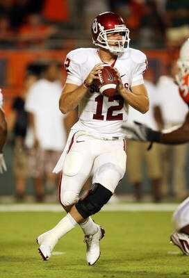 MIAMI GARDENS, FL - OCTOBER 03:  Quarterback Landry Jones #12 of the Oklahoma Sooners drops back to pass against the Miami Hurricanes at Land Shark Stadium on October 3, 2009 in Miami Gardens, Florida. Miami defeated Oklahoma 21-20.  (Photo by Doug Benc/G