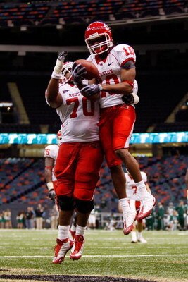 NEW ORLEANS - OCTOBER 17:  L.J. Castile #10  celebrates with Chris Thompson #70 of the Houston Cougars celebrate after scoring a touchdown against the Tulane Green Wave at the Louisiana Superdome on October 17, 2009 in New Orleans, Louisiana. The Cougars 
