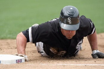 CHICAGO - JUNE 17:  Scott Podsednik #22 of the Chicago White Sox slides to a base against the Chicago Cubs on June 17, 2009 at Wrigley Field in Chicago, Illinois. (Photo by Jonathan Daniel/Getty Images)