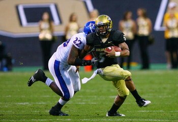 BOULDER, CO - OCTOBER 17: Rodney Stewart #5 of the Colorado Buffaloes tries to break the tackle of Agnus Quigley #22 of the Kansas Jayhawks during the game at Folsom Field on October 17, 2009 in Boulder, Colorado. (Photo by Garrett W. Ellwood/Getty Images