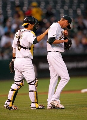 OAKLAND, CA - SEPTEMBER 04:  Catcher Kurt Suzuki #8 of the Oakland Athletics consoles pitcher Clayton Mortensen #62 in the second inning of their game against the Seattle Mariners at the Oakland Coliseum on September 4, 2009 in Oakland, California.  (Phot