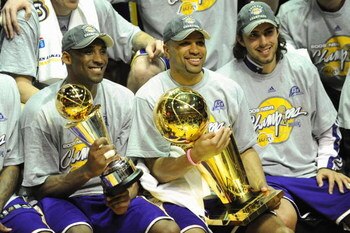 ORLANDO, FL - JUNE 14:  Kobe Bryant #24 of the Los Angeles Lakers holds the Bill Russell MVP trophy and Derek Fisher #2 of the Lakers holds the Larry O'Brien trophy after defeating the Orlando Magic in Game Five of the 2009 NBA Finals on June 14, 2009 at 