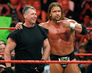 LAS VEGAS - AUGUST 24:  World Wrestling Entertainment Inc. Chairman Vince McMahon (L) and wrestler Triple H appear in the ring during the WWE Monday Night Raw show at the Thomas & Mack Center August 24, 2009 in Las Vegas, Nevada.  (Photo by Ethan Miller/G