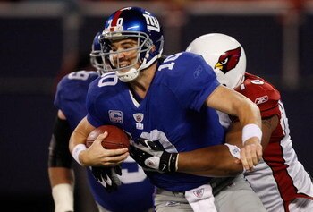 EAST RUTHERFORD, NJ - OCTOBER 25: Eli Manning #10 of the New York Giants is sacked in the second half by Alan Branch #78 of the Arizona Cardinals on October 25, 2009 at Giants Stadium in East Rutherford, New Jersey. (Photo by Jared Wickerham/Getty Images)