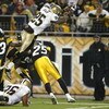 PITTSBURGH - NOVEMBER 12:  Reggie Bush #25 of the New Orleans Saints jumps for the end zone to score a touchdown over Ryan Clark #25 of the Pittsburgh Steelers  on November 12, 2006 at Heinz Field in Pittsburgh, Pennsylvania.  (Photo by Rick Stewart/Getty
