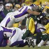 GREEN BAY, WI - DECEMBER 21:  Donald Driver #80 of the Green Bay Packers fights for yardage as he is tackled by Kevin Williams #93 and Dwight Smith #24 of the Minnesota Vikings on December 21, 2006 at Lambeau Field in Green Bay, Wisconsin. (Photo by Jonat