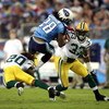 NASHVILLE, TN - SEPTEMBER 3: Chris Johnson #28 of the Tennessee Titans attempts to jump over defenders Atari Bigby #20 and Brandon Underwood #33 of the Green Bay Packers during a preseason NFL game at LP Field on September 3, 2009 in Nashville, Tennessee.