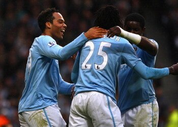 MANCHESTER, ENGLAND - OCTOBER 25:  Joleon Lescott of Manchester City celebrates with Emmanuel Adebayor after scoring the opening goal during the Barclays Premier League match between Manchester City and Fulham at the City of Manchester Stadium on October 