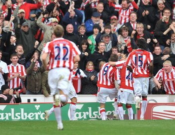 STOKE ON TRENT, ENGLAND - OCTOBER 17:  James Beattie of Stoke celebrates scoring their second goal as he kicks the advertising board during the Barclays Premier League match between Stoke City and West Ham United  at the Britannia Stadium on October 17, 2
