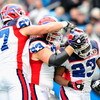 CHARLOTTE, NC - OCTOBER 25:  Andy Levitre #67, Geoff Hangartner #63 and Marshawn Lynch #23 of the Buffalo Bills during celebrate Lynch's touchdown against the Carolina Panthers at Bank of America Stadium on October 25, 2009 in Charlotte, North Carolina.  