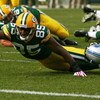 GREEN BAY, WI - OCTOBER 18: Greg Jennings #85 of the Green Bay Packers stretches to reach the goal line as he's tackled by Demarcus Faggins #38 of the Detroit Lions at Lambeau Field on October 18, 2009 in Green Bay, Wisconsin. The Packers defeated the Lio